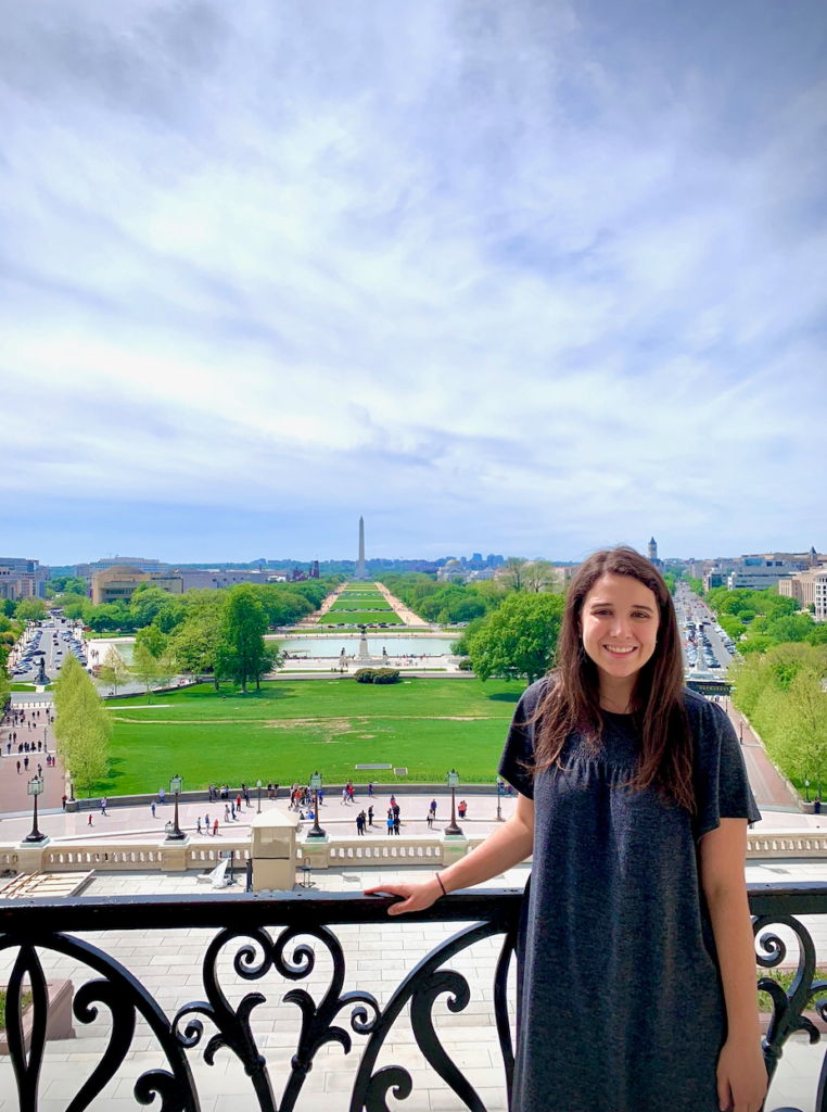 Luisa Ferrari with the National Mall behind her in a photo taken from the Speaker's Balcony of the U.S. Capitol Building