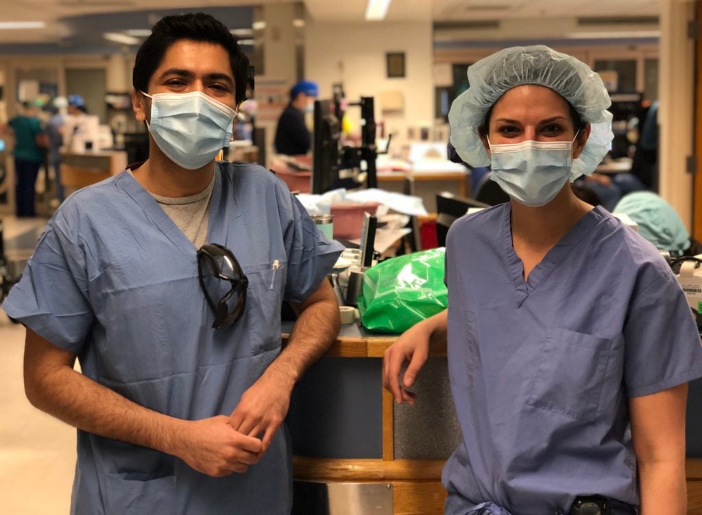 Dr. Jaskaran Singh and Dr. Laura Boitano in clinical attire in hospital