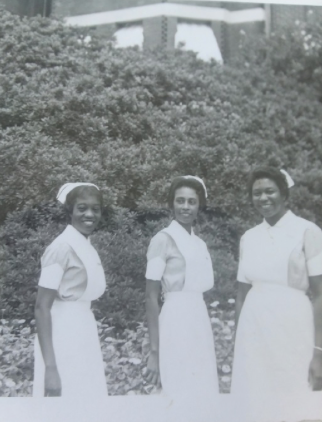 Dr. Bernardine Lacey (center) stands in an early 1960s photo in a nursing uniform with classmates at the Gilfoy School of Nursing.