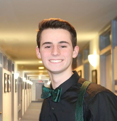 Thomas Joyce (NHS'23) stands in a lighted hallway in the Old North Building on campus.