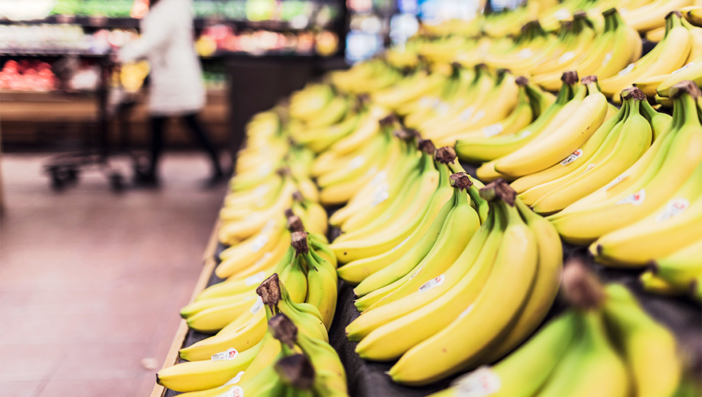 Bananas on a shelf in a grocery store