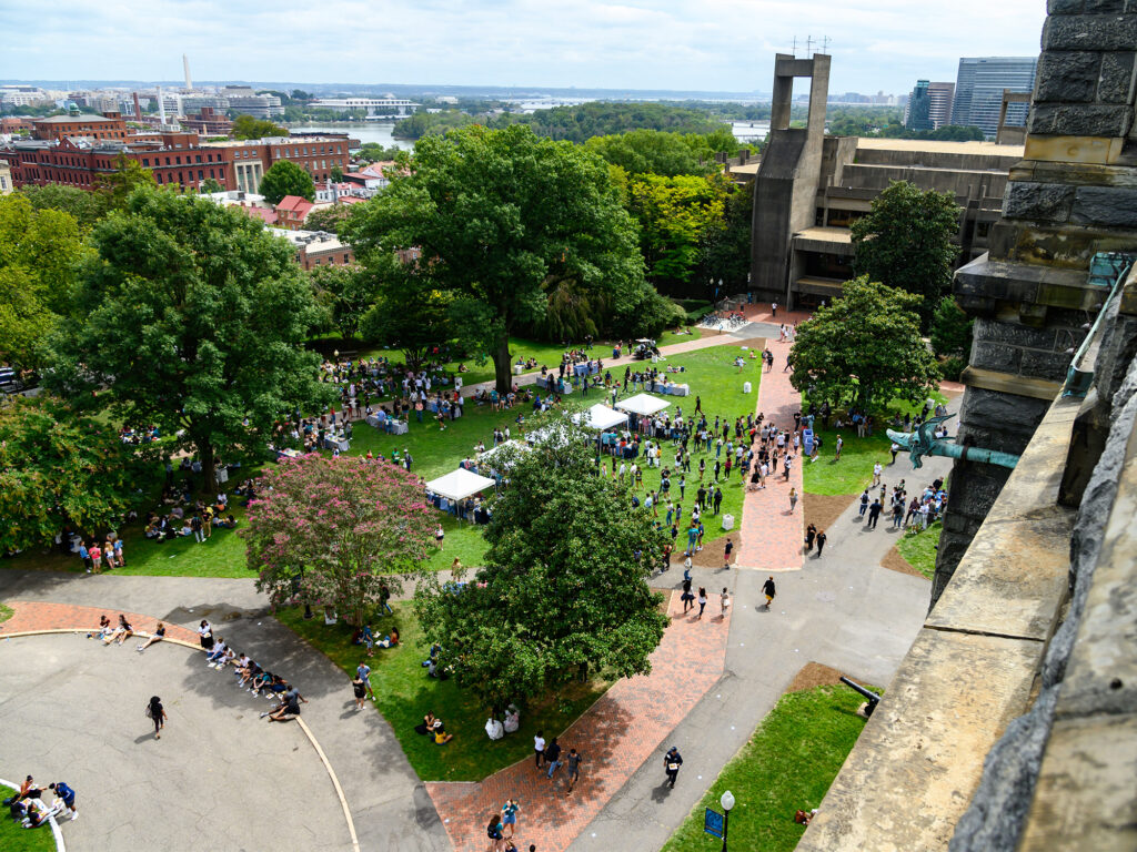 Students mill around at an event in this image taken from high above