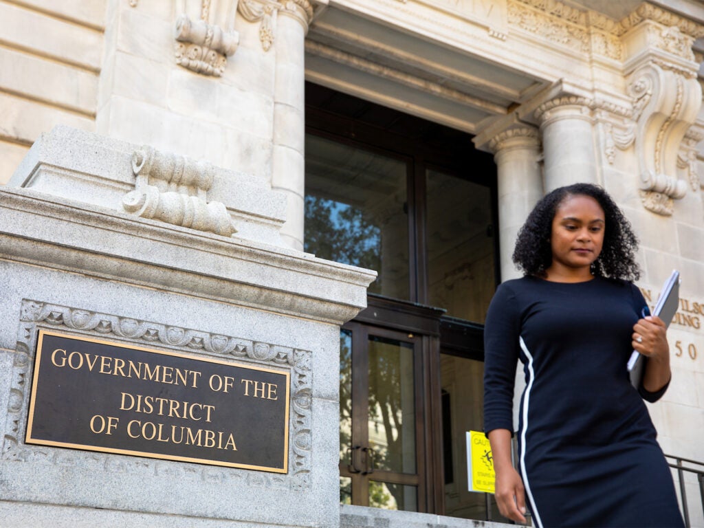 A student walks down the steps of the building for DC Government