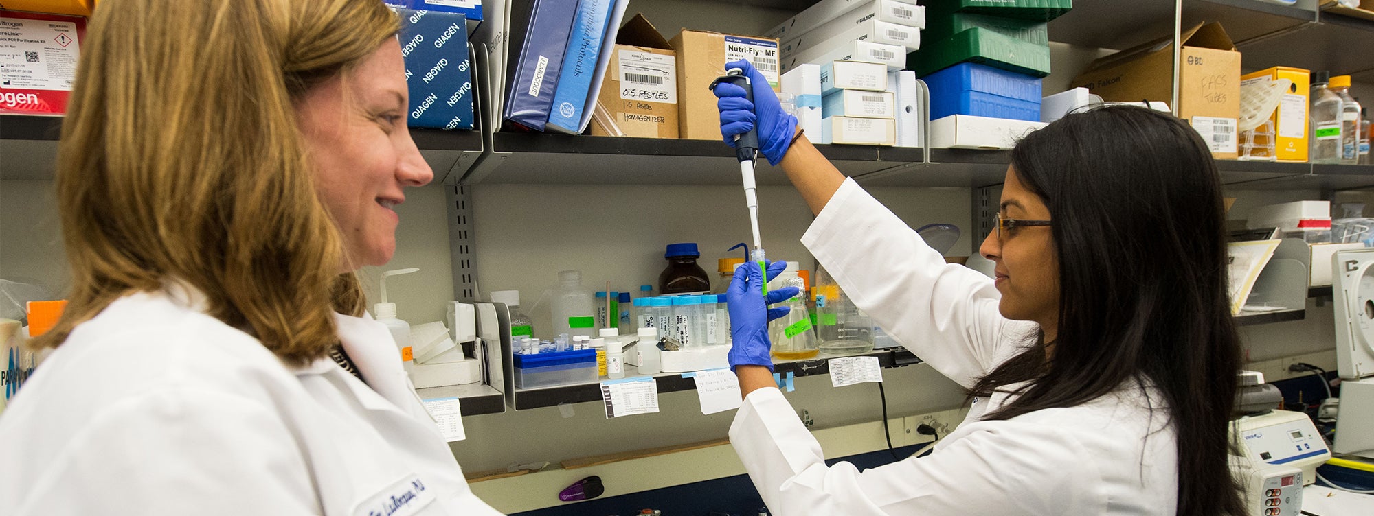 A student works in the Discovery Center under the watchful gaze of a faculty member