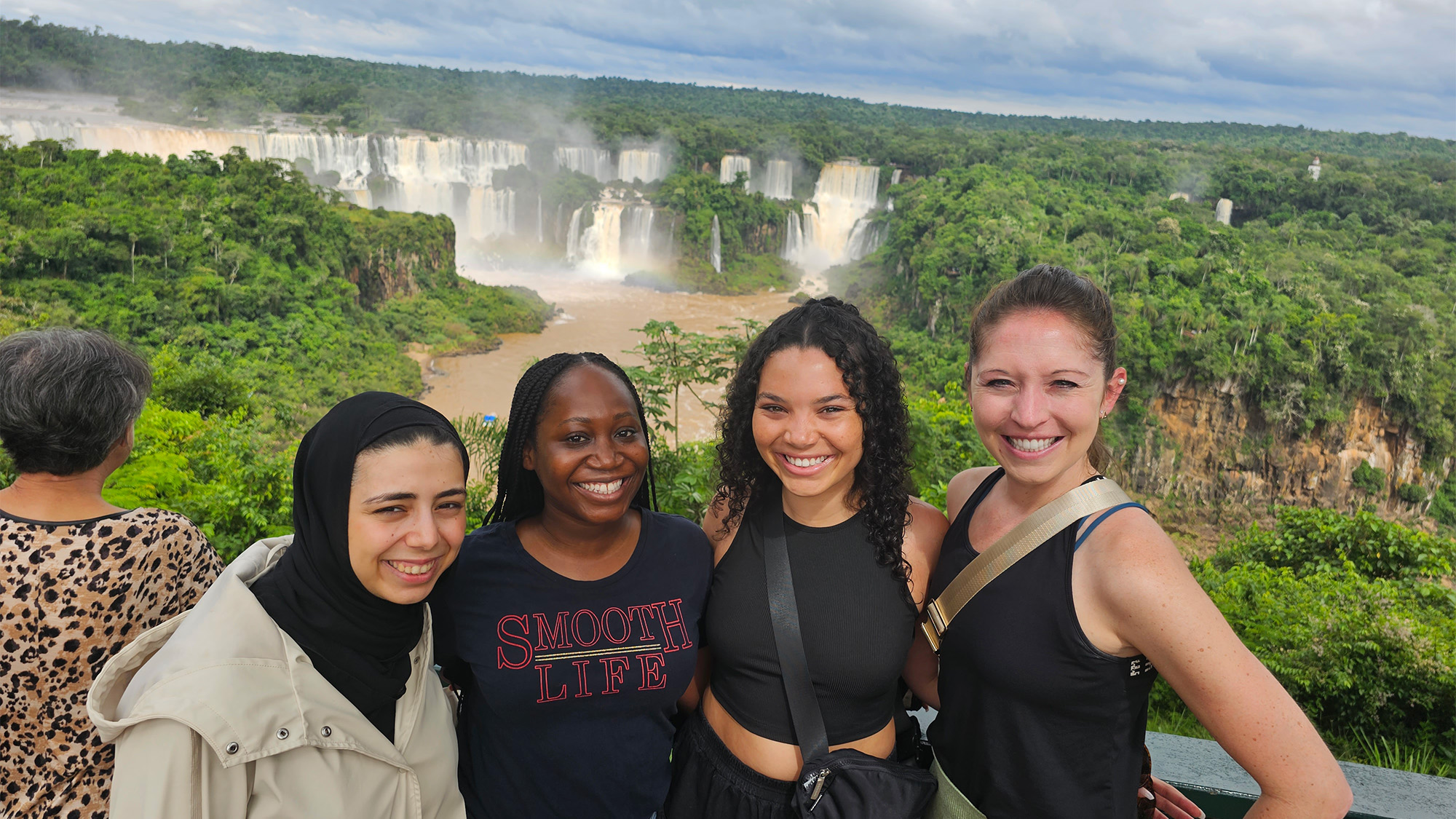 Students stand with Iguazu Falls in the background
