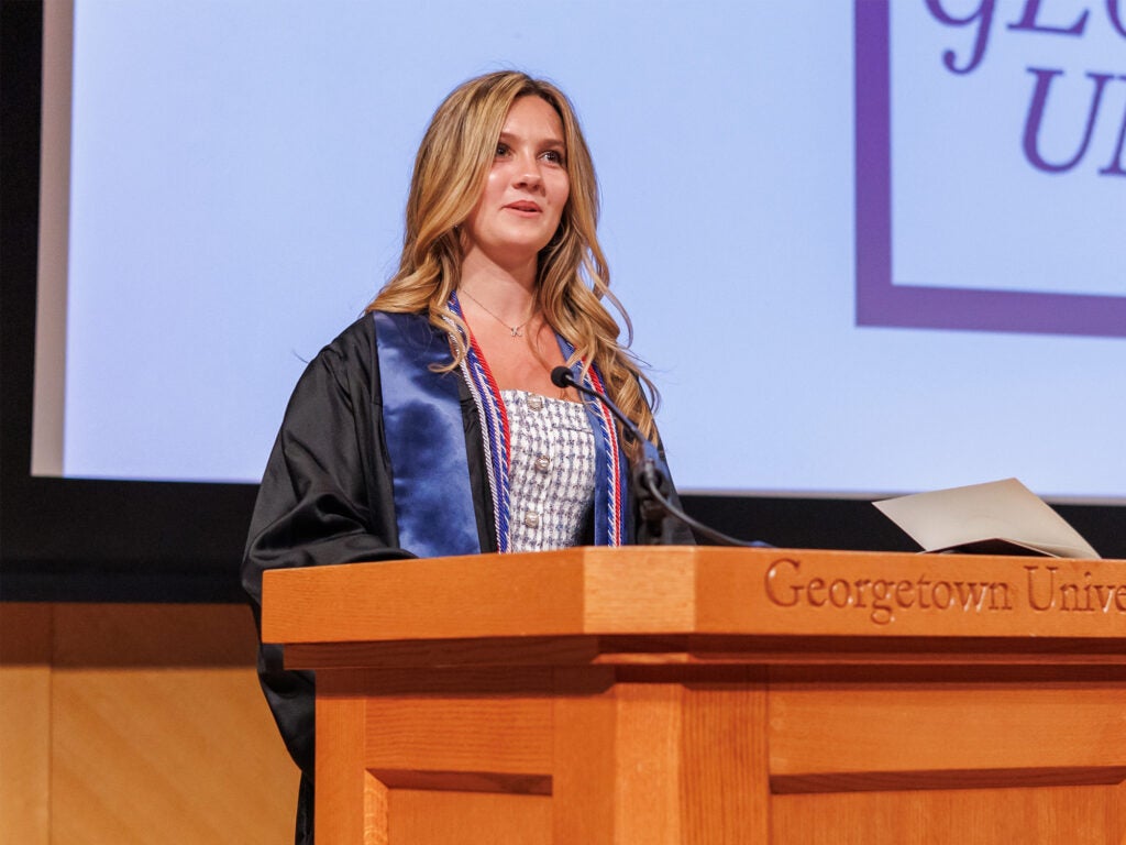 Kate Gabriel speaks from a podium