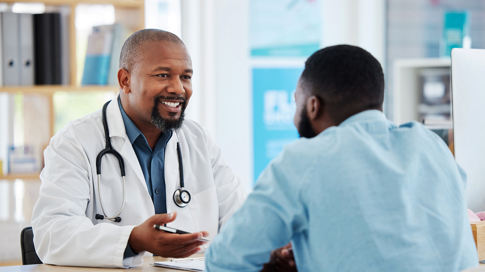 A black patient speaks to his black doctor
