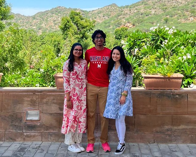 Three students stand together