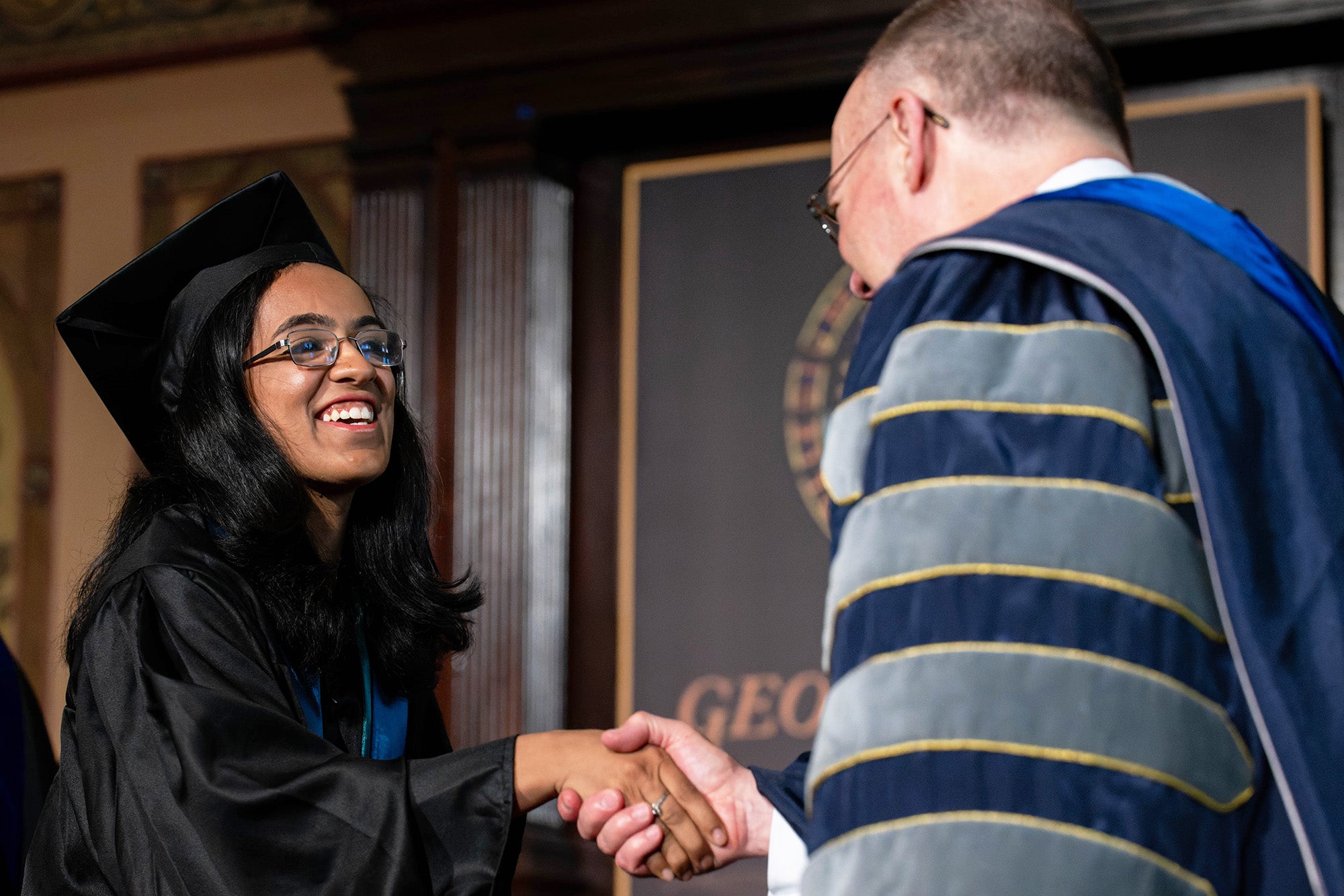 Shreyaa Venkat shakes hands with President DeGioia