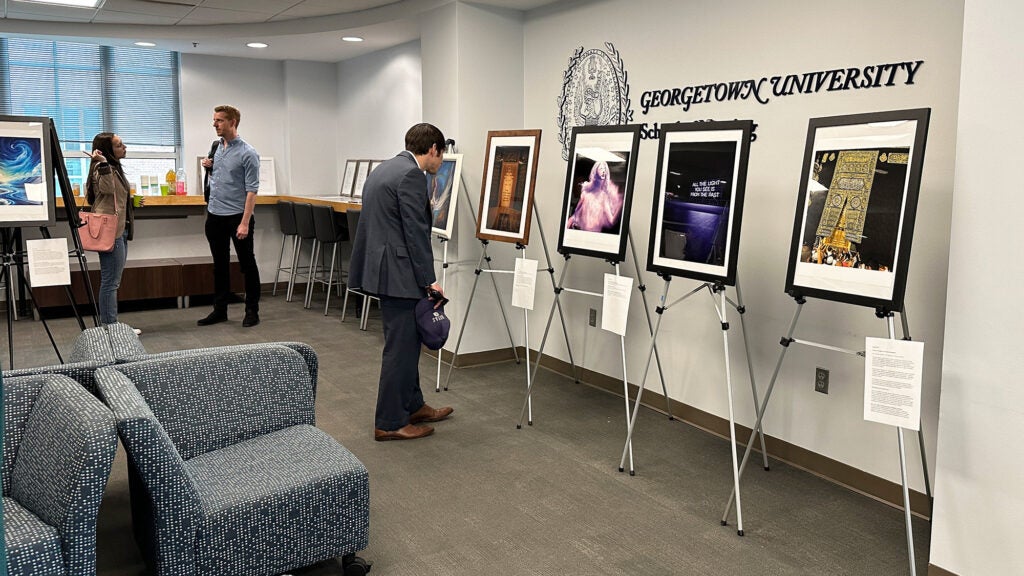 People look at artwork on display as part of a show highlighting mental health