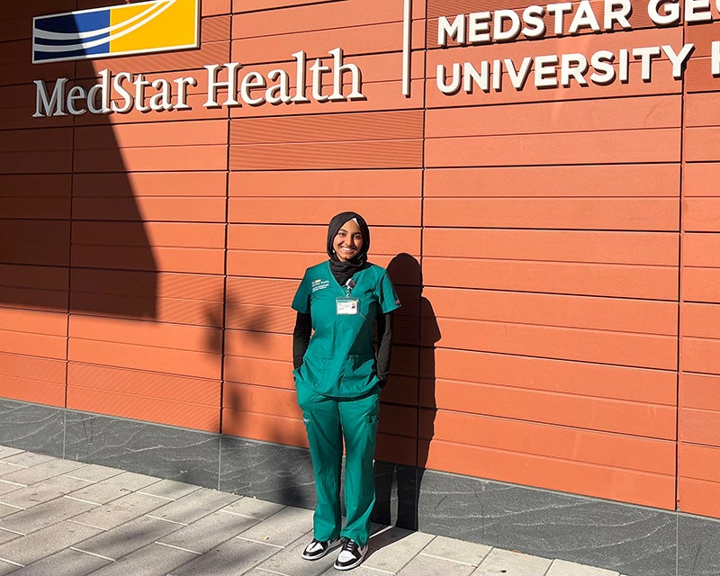 Isra Satiar stands outside the entrance to MedStar Georgetown University Hospital's Verstandig Pavilion