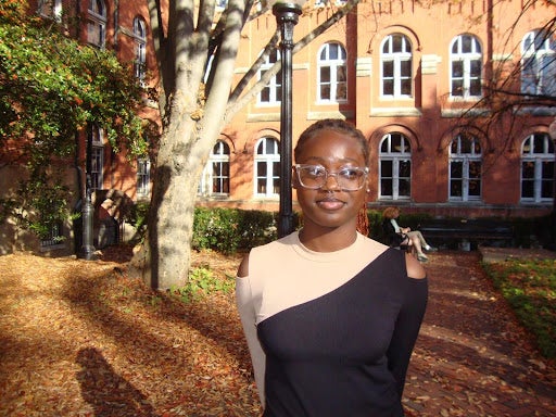 Fathia Fasasi (H’27) standing outside of a campus building in the Fall