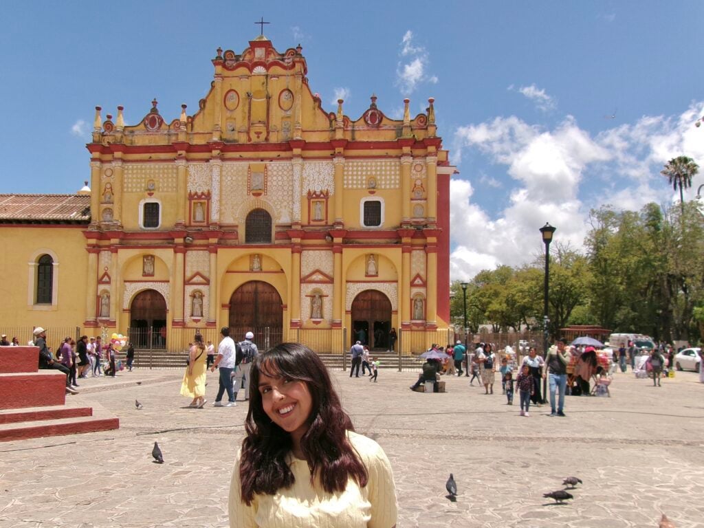 Student standing in front of church in San Cristobal de las Casas, Mexico