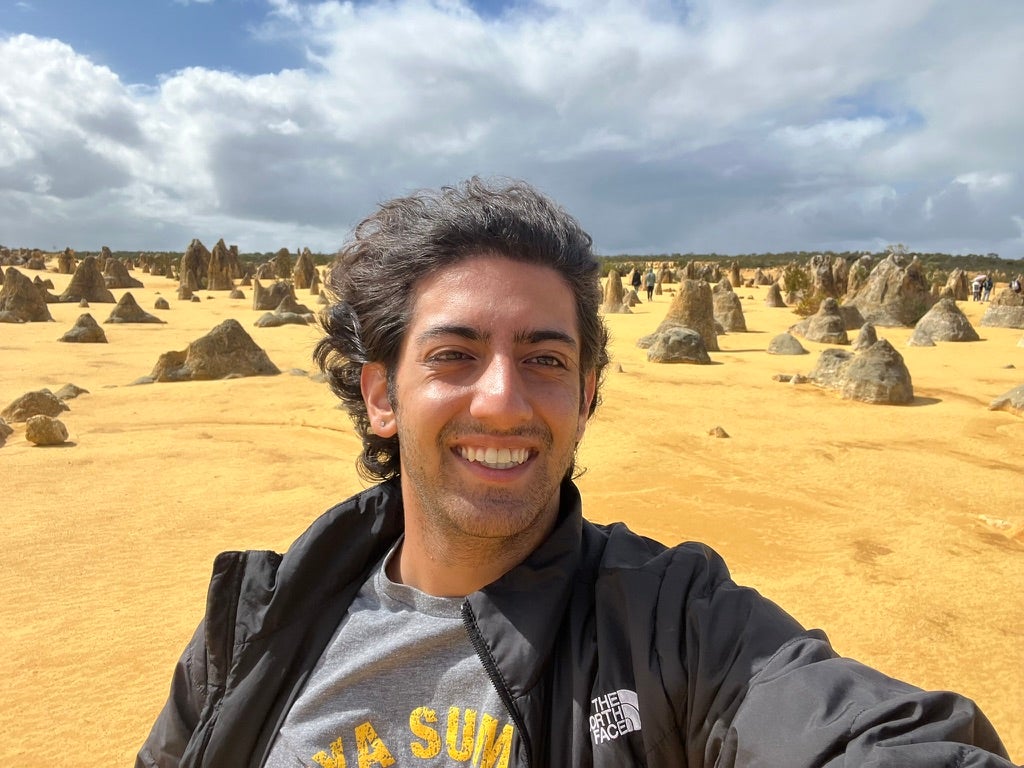 Student in Western Australia with rock formations in background