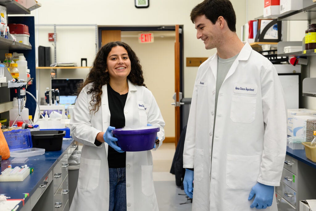 A male and female student work in the lab