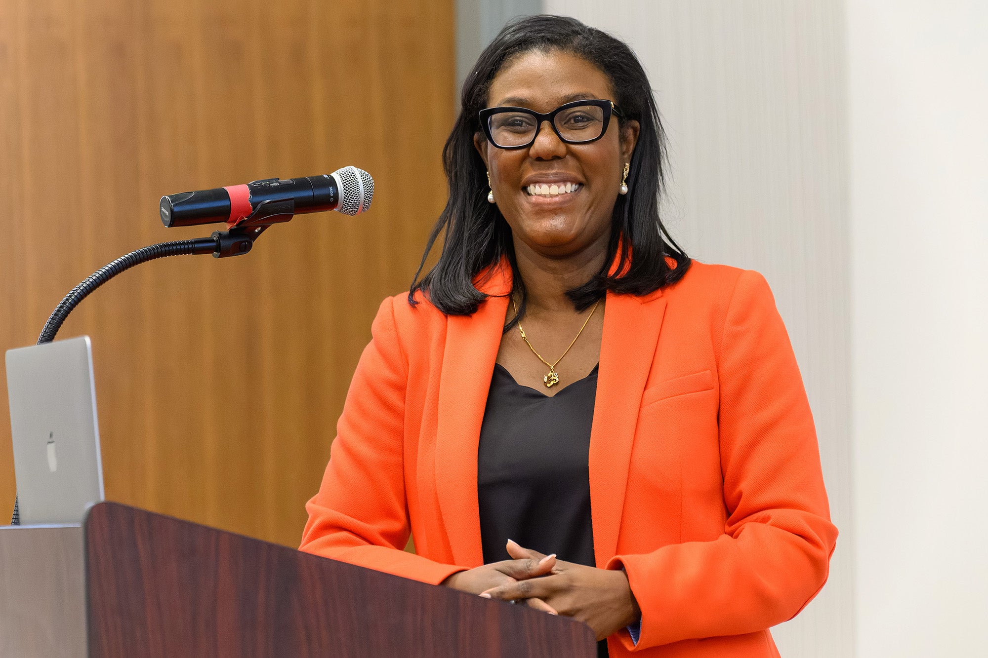 Dr. Joseph stands behind a podium for her presentation