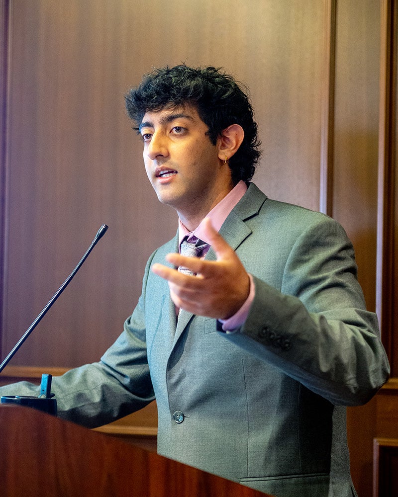 Argun Chhabra speaks from a podium