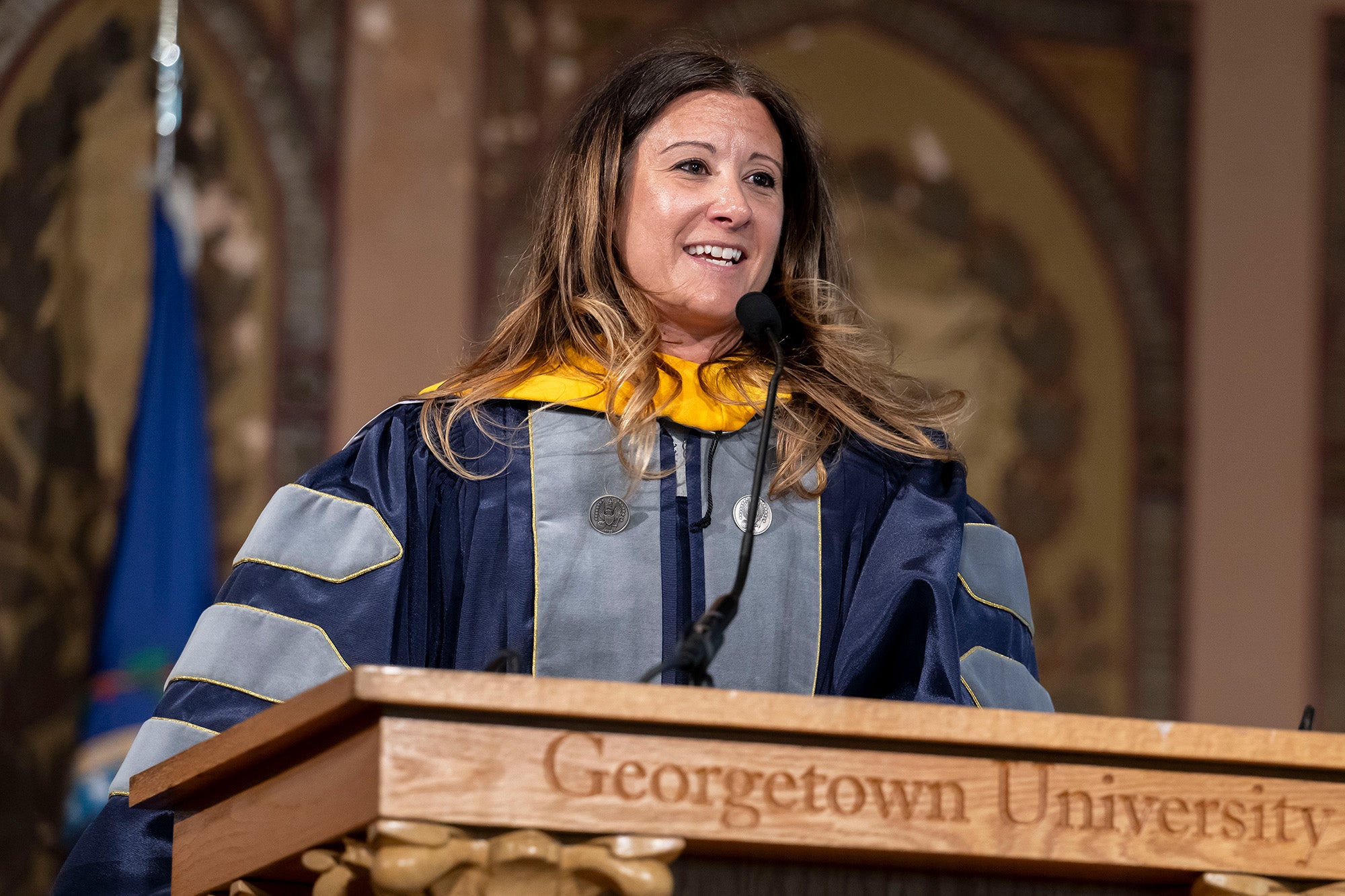 Maria Van Kerkhove speaks from a podium