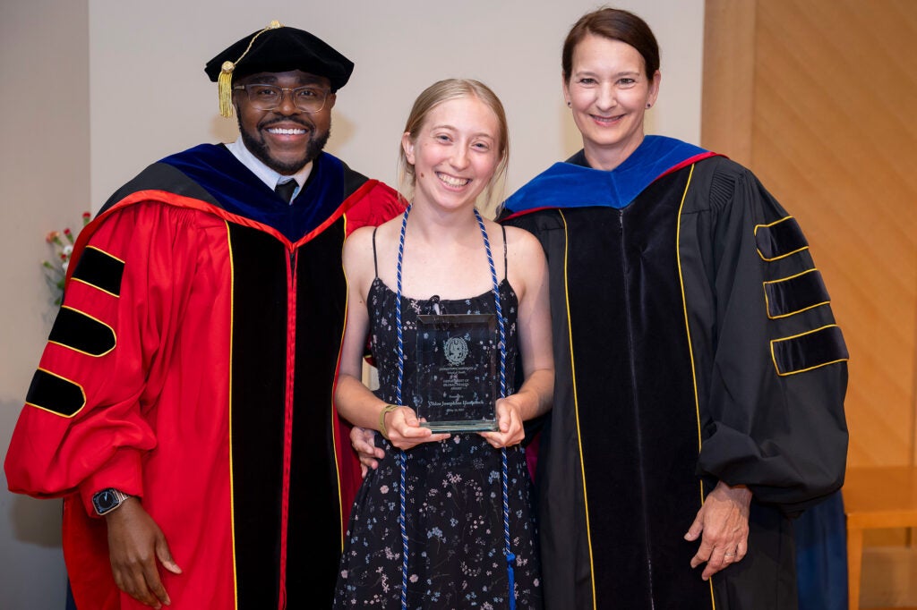 Dean King and Myrian Vuckovic stand with student Chloe Hammock