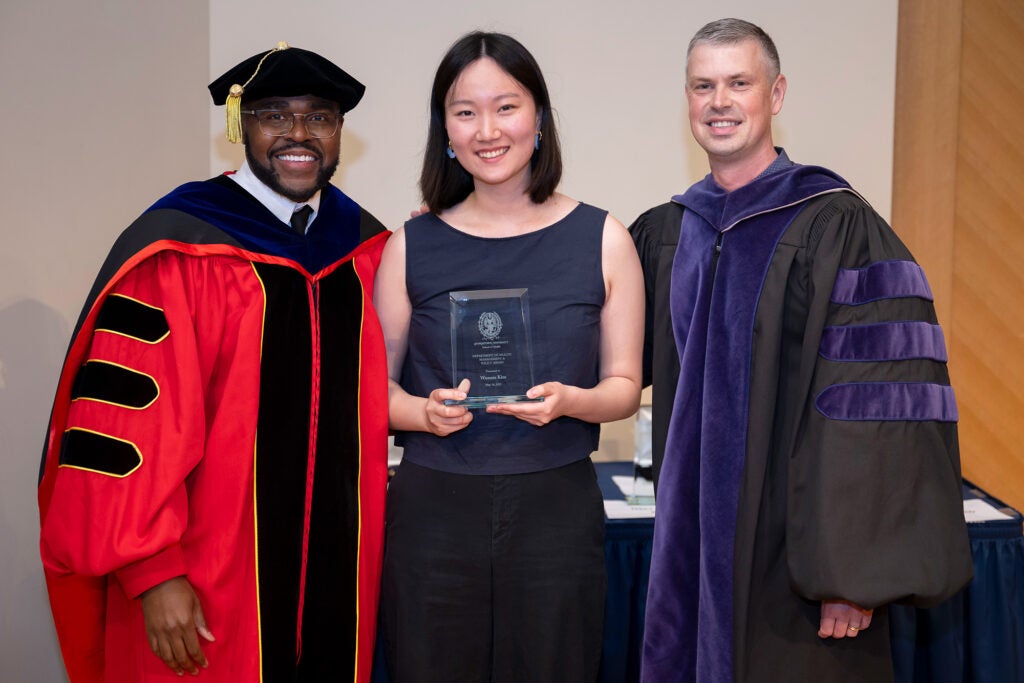Dean King and John Kraemer stand with Wonnie Kim