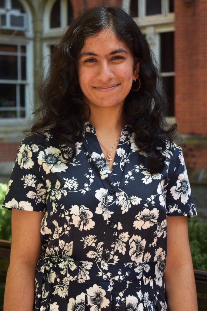 Sahana Arumani stands outdoors on campus