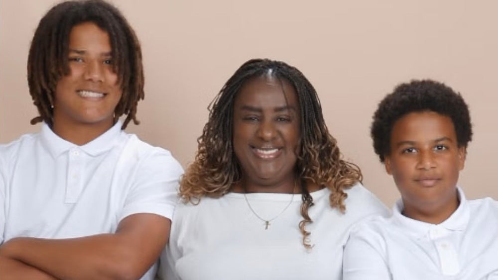 Martha Cameron stands between her two sons