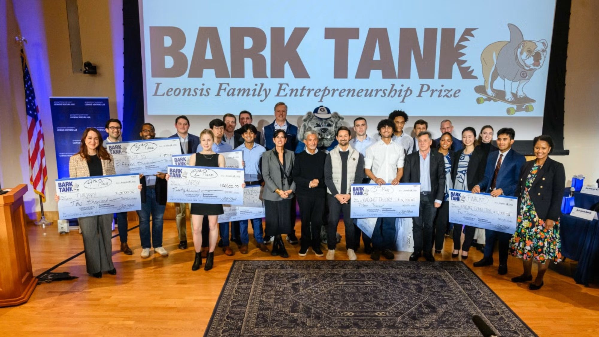 The 2025 Bark Tank participants stand in a group onstage