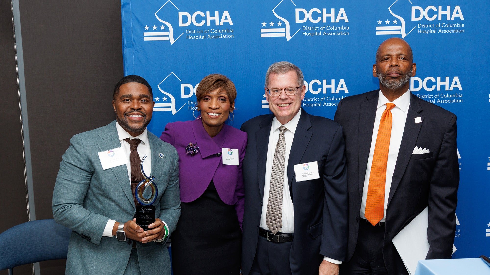 Dr. King stands with three individuals