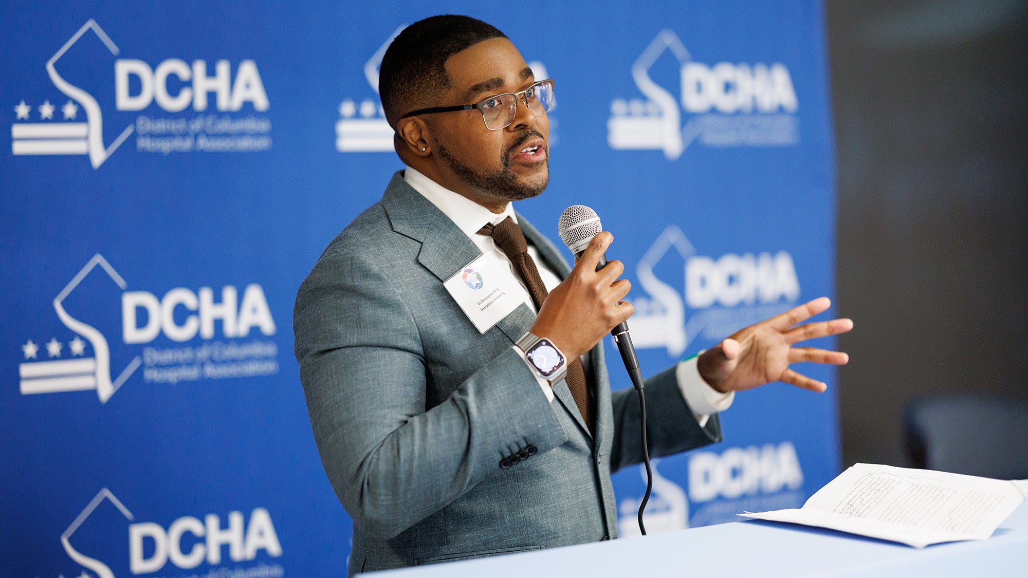 Dr. King speaks into a microphone from a podium