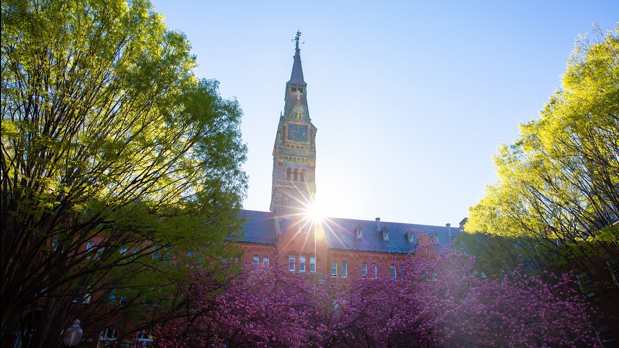 The sun rises over the roof of Dahlgren with Healy clocktower in view