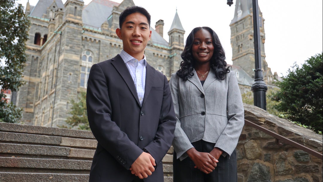 Jordan Pai and Kayla Wontumi stand on steps near Healy Hall