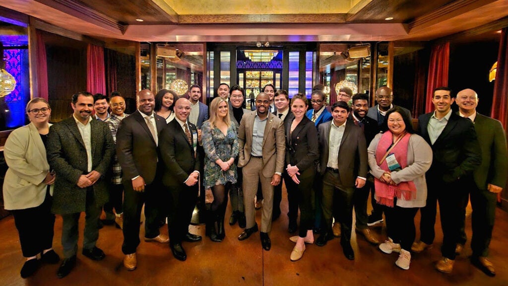 Participants in the ACHE conference stand together as a group