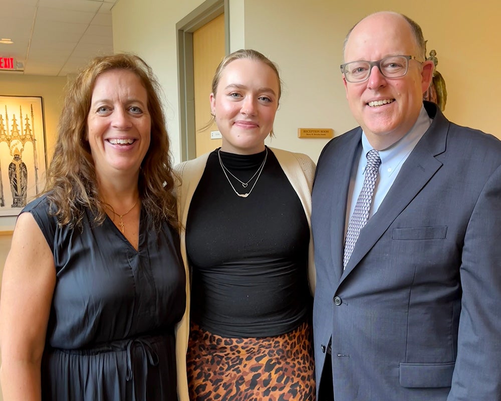 Katie, center, stands with her mom and dad