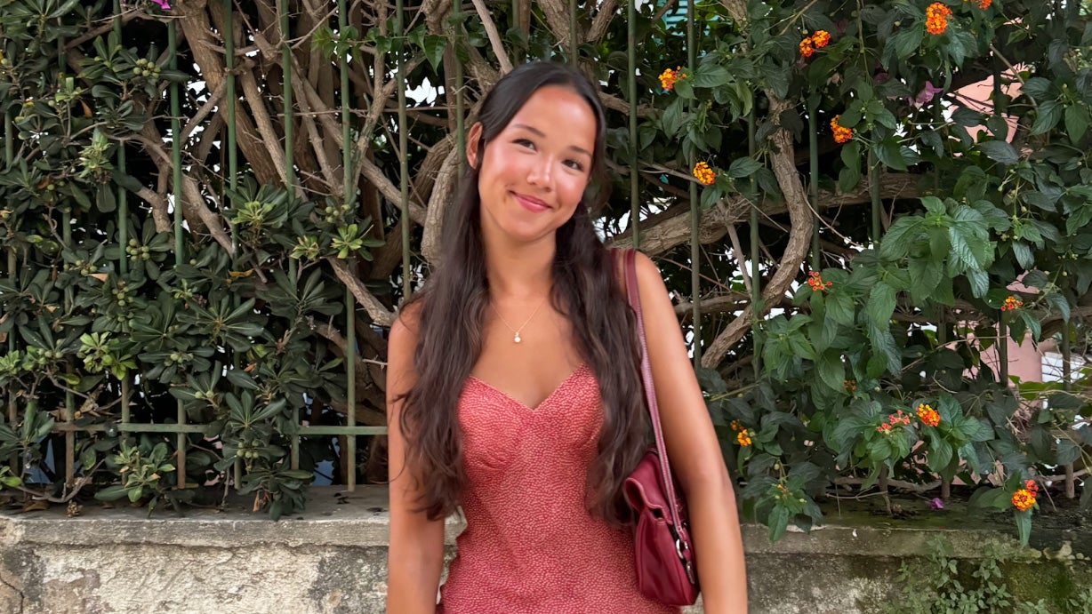 Myha Hill stands against a background of greenery