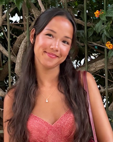 Myha Hill stands against a background of greenery