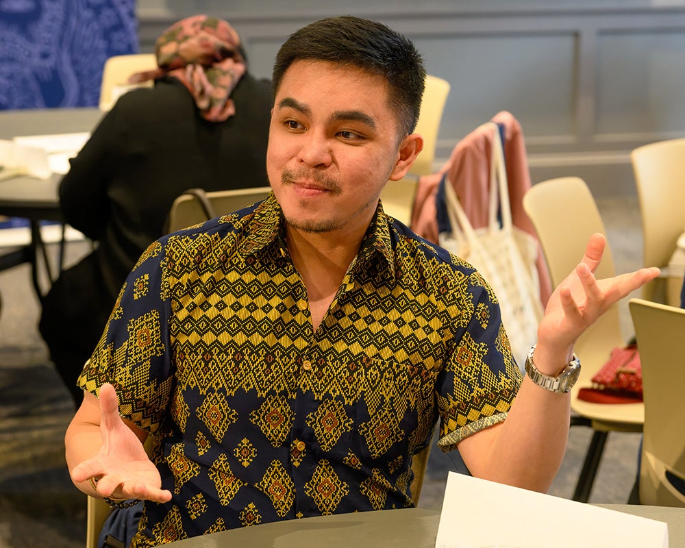 Global health preceptor Geminn Louis C. Apostol sits at a table