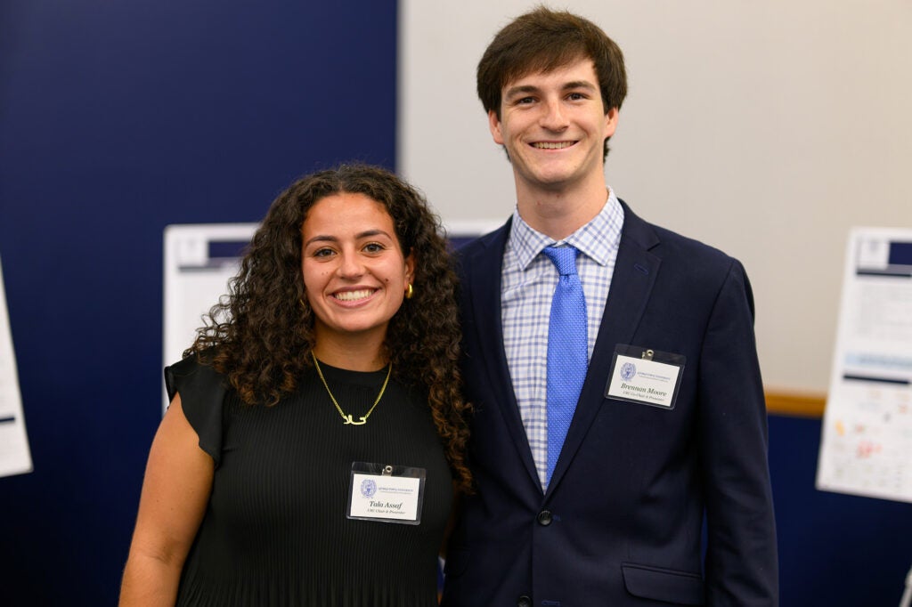 Two students stand together in the conference hall