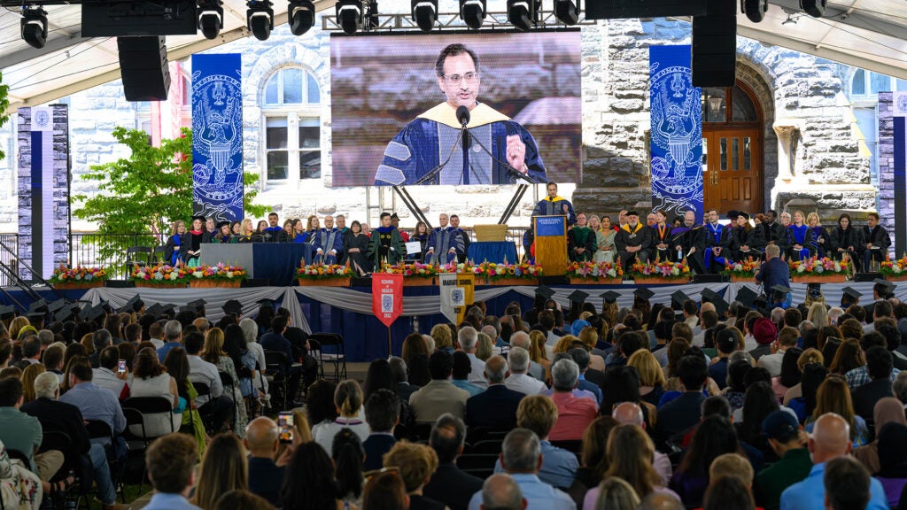 A view of the stage at Commencement from the back of the tent on Healy Lawn