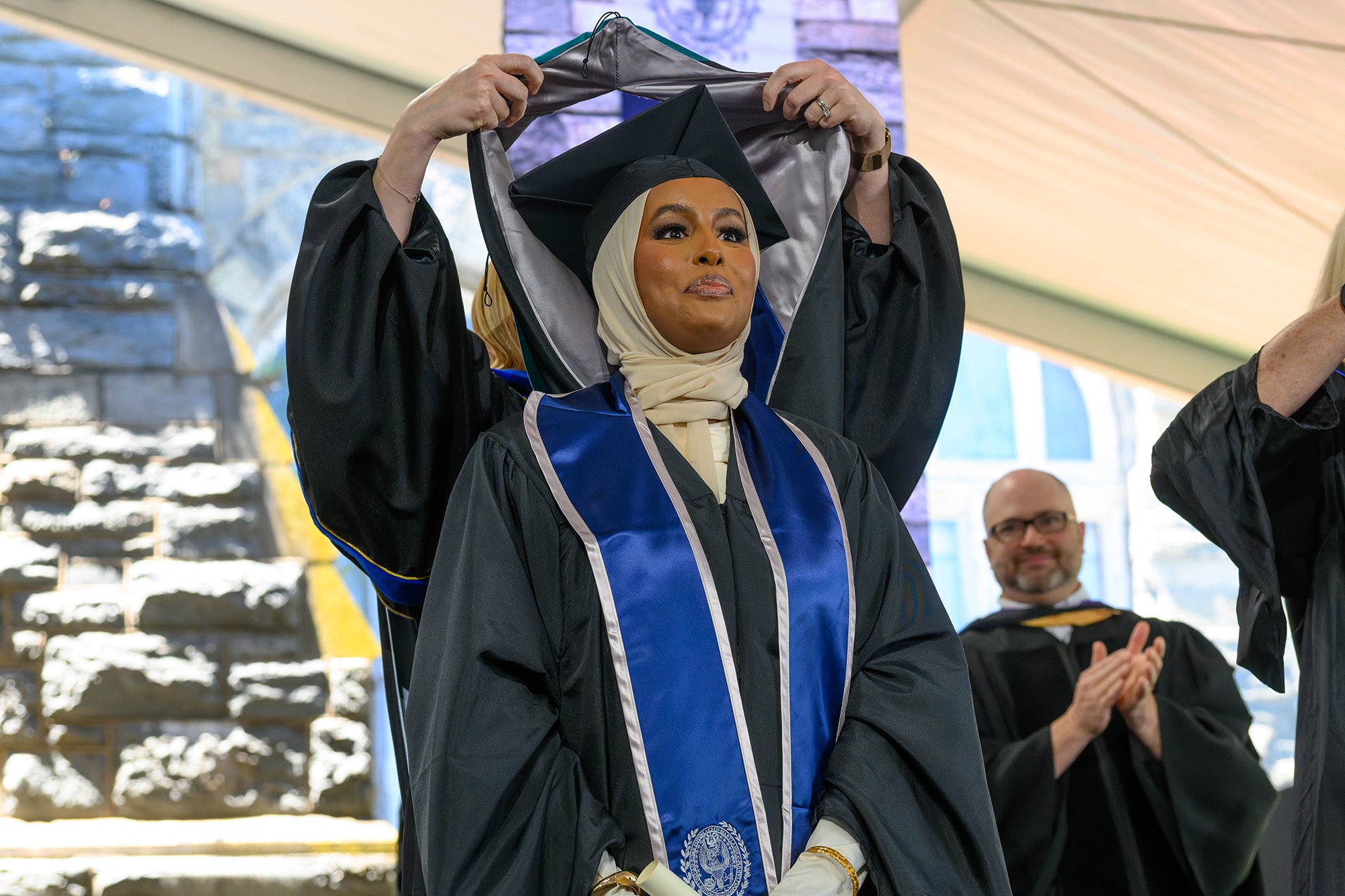 A female graduate is hooded