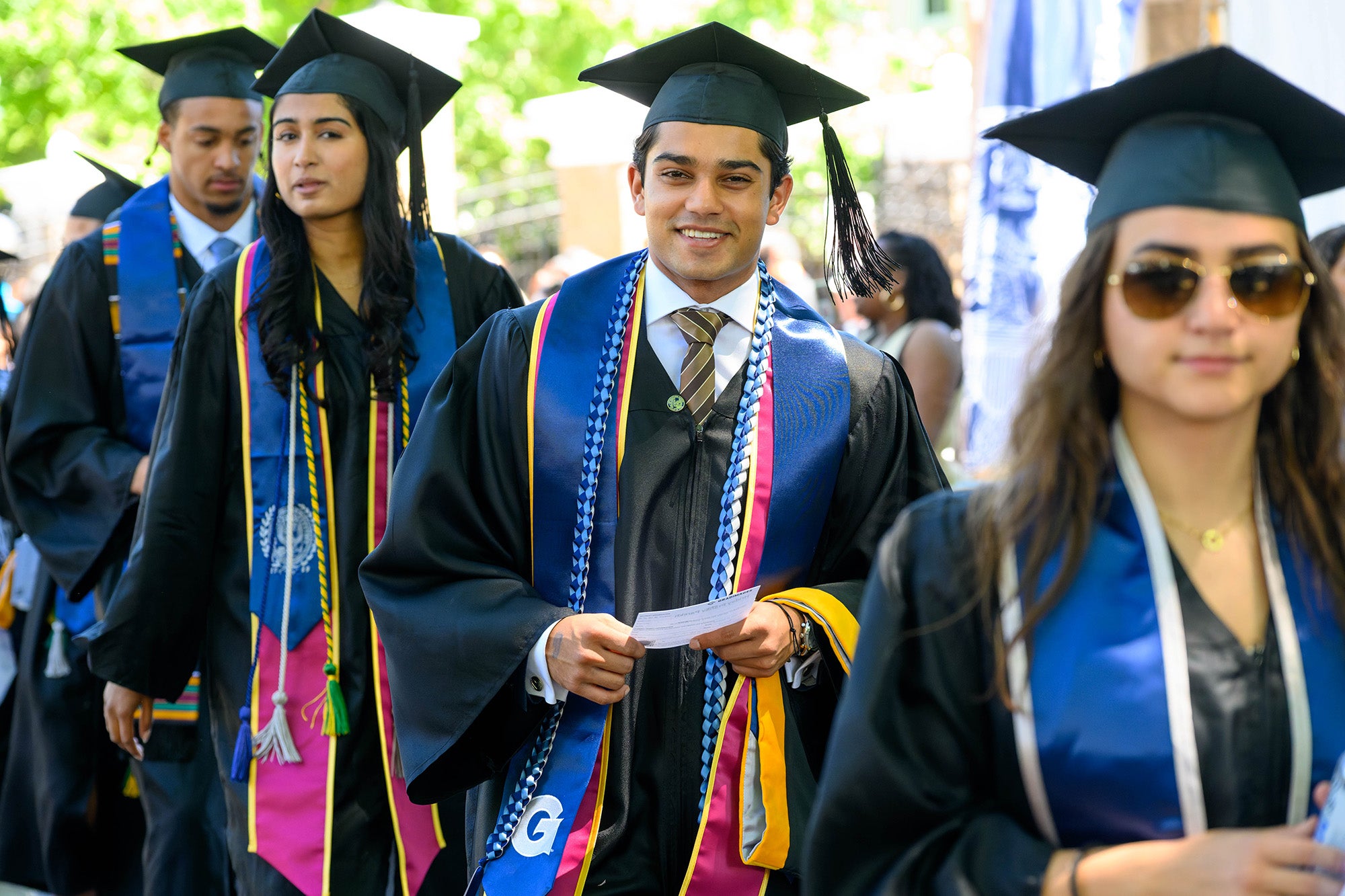 Undergraduate students line up to walk the stage