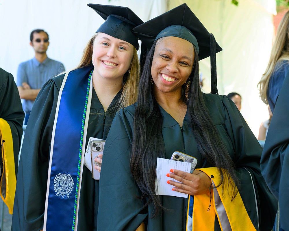 Two students stand together