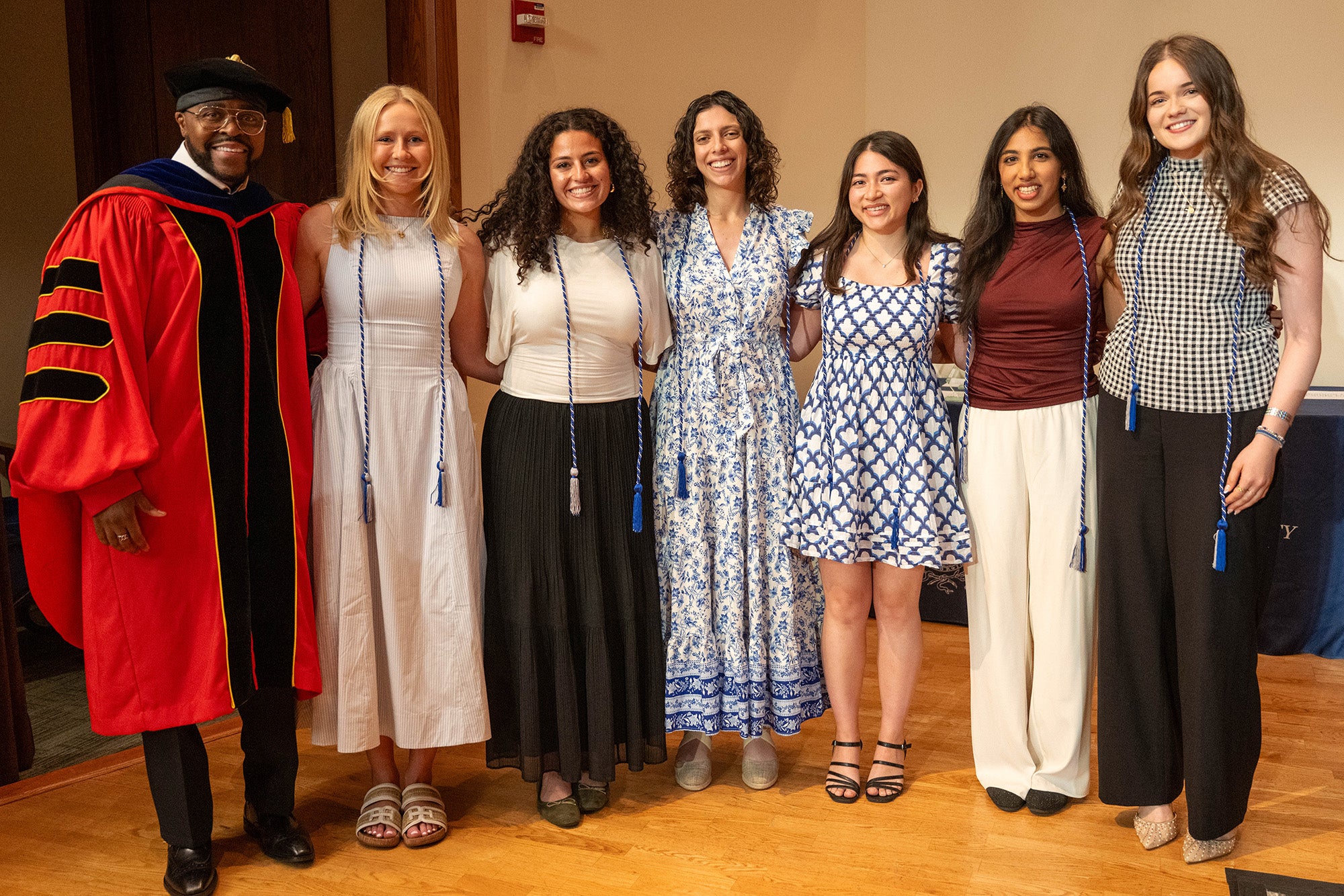 Seven individuals stand together