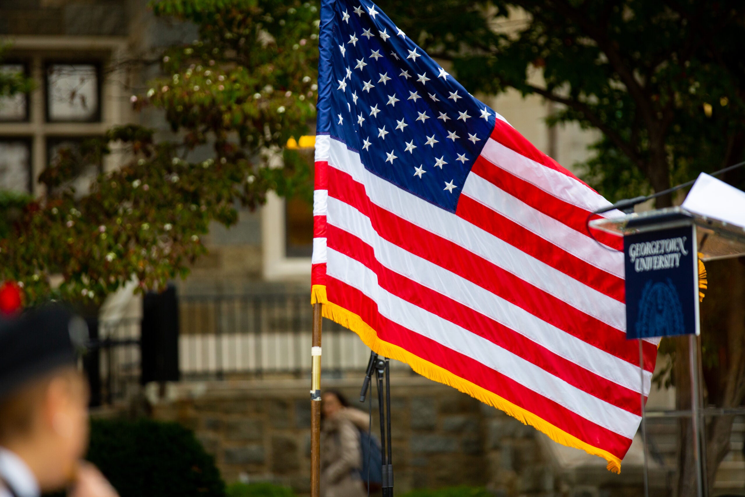 American flag in front of a campus building