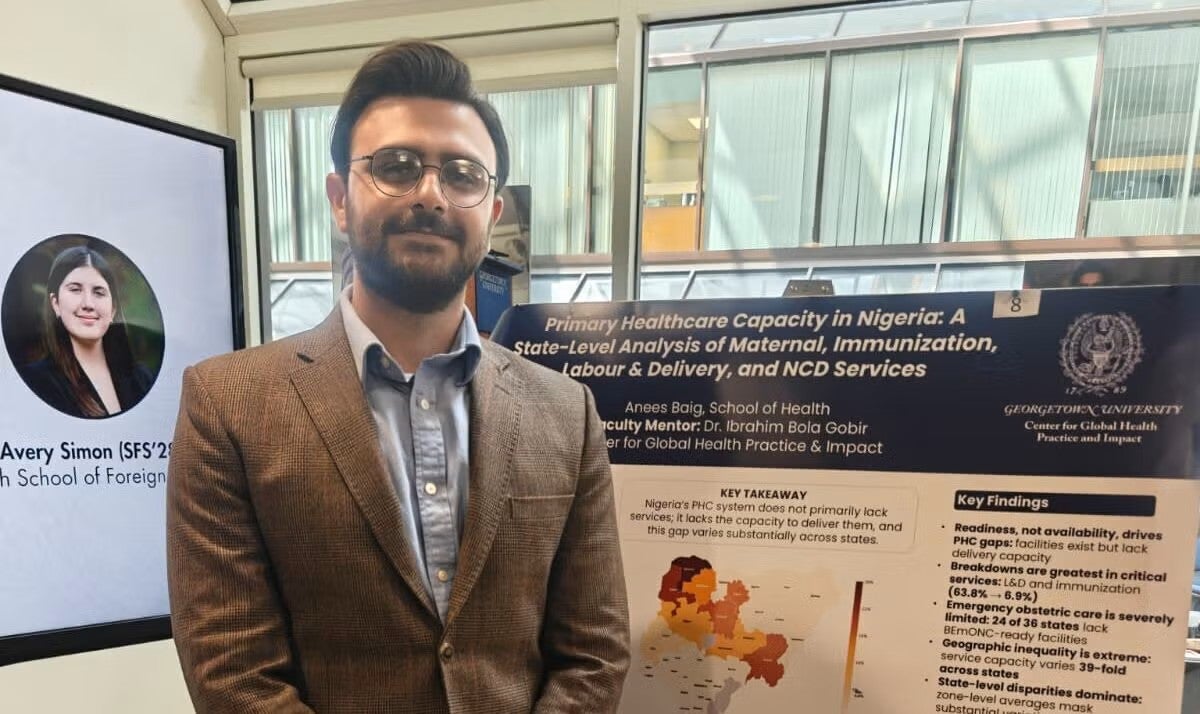 Anees Baig stands in front of his research poster